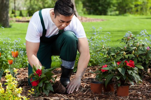 Gardeners working carefully with health and safety measures in place